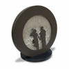 Front view of the illuminated 32cm moon table lamp emitting a warm, ambient glow that dynamically catches the realistic, textured craters behind the dark romantic silhouette.