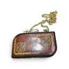 Close-up view of the fine hand-painted artwork and rich leather texture on a structured designer clutch.