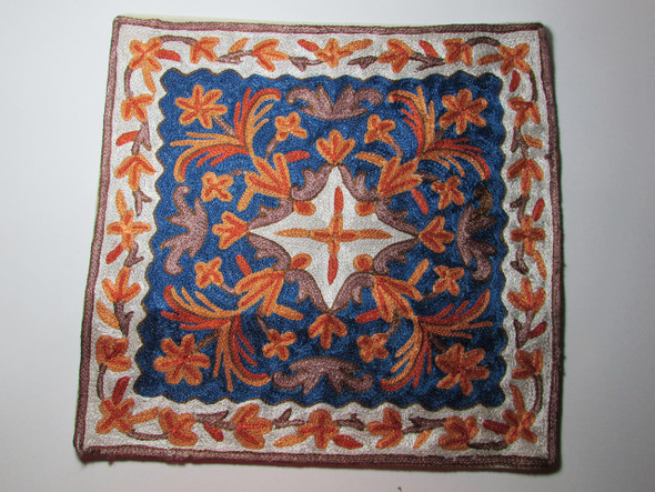 A vibrant Indian hand-embroidered cushion cover with traditional Kashmiri Suzani floral patterns.