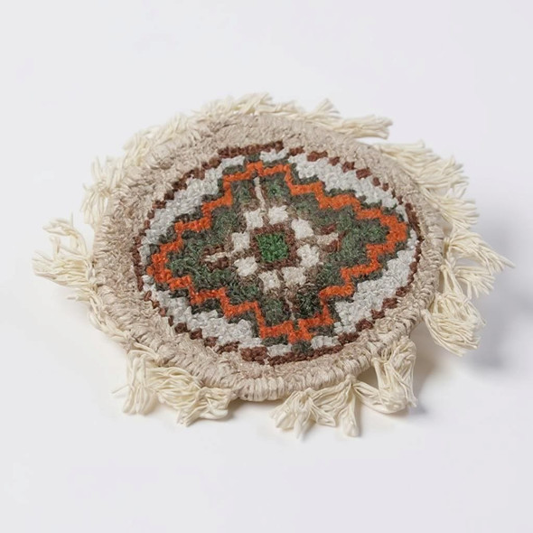 High-quality round tea coasters that mimic the look and feel of traditional carpets, sized at 9-10 cm.