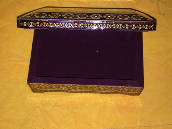A beautifully crafted wooden gift box showcasing traditional Persian Khatamkari mosaic artistry and vibrant decorative motifs.