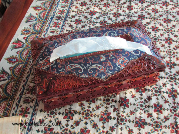 A beautifully detailed tissue box holder with hand-cut leather ornamentation