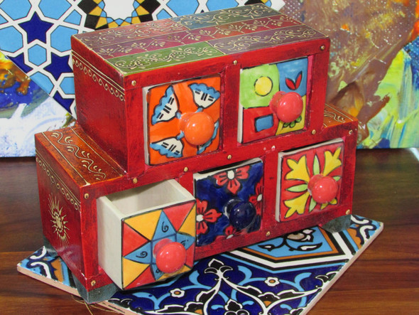 A beautiful bedroom storage chest with five drawers, each decorated with distinct, hand-painted Indian artistic motifs.