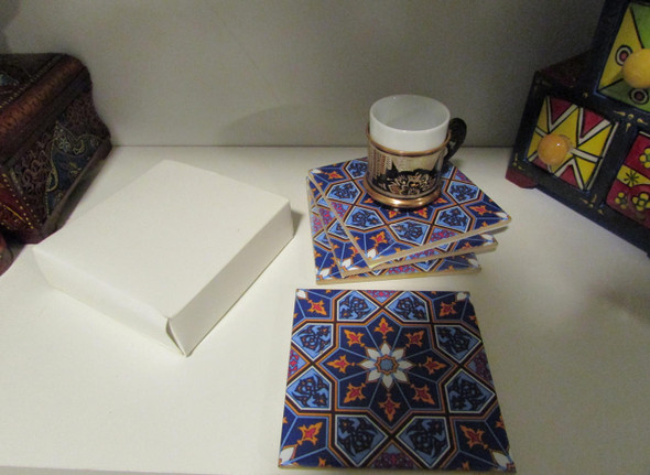An artisan ceramic tea coaster set featuring a timeless geometric star print, perfect for adding a touch of heritage and color to any home decor setting.