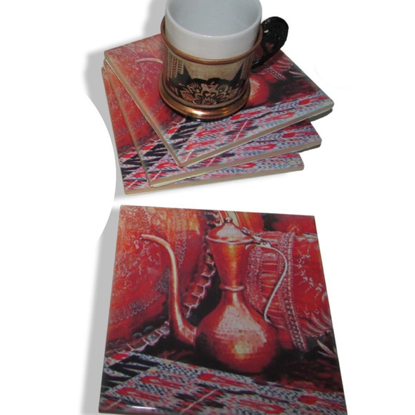 The set of four square ceramic coasters displayed with a coffee cup, highlighting their aesthetic appeal and utility in home decor.