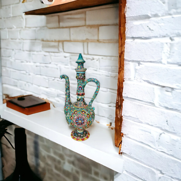 A beautiful handcrafted pottery pitcher featuring hand-painted embossed patterns and a sturdy handle, perfect for elegant home decor.
