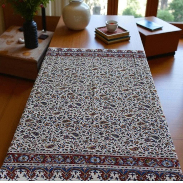 A premium 100x100 cm handmade cotton tablecloth titled "The Meadow Square" featuring dense indigo and red block-printed floral patterns.