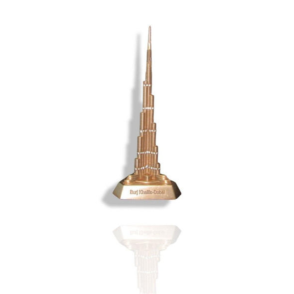 A sleek metal Burj Khalifa ornament placed on a professional office desk, representing modern architectural style.