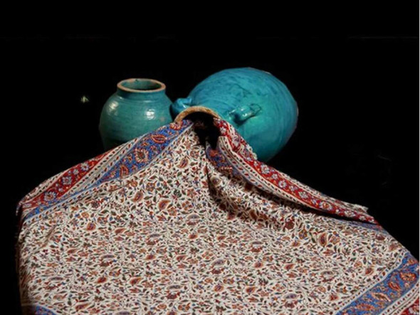 Side-angle shot of a thick cotton tapestry cloth showcasing the texture and vibrant floral ink