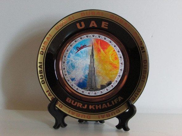 A 11.5 cm decorative ceramic plate featuring the Burj Khalifa and a golden border, suitable for wall hanging or table decor.