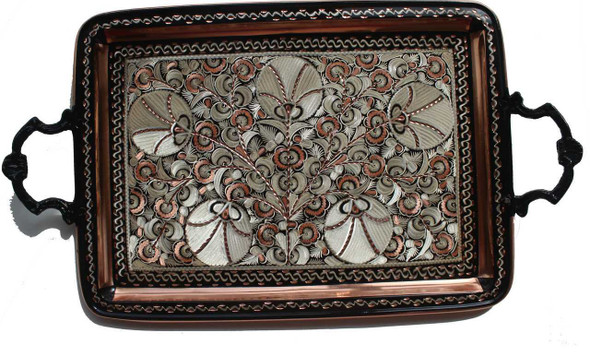 A large, circular engraved copper tray featuring traditional Persian floral carvings and a polished finish