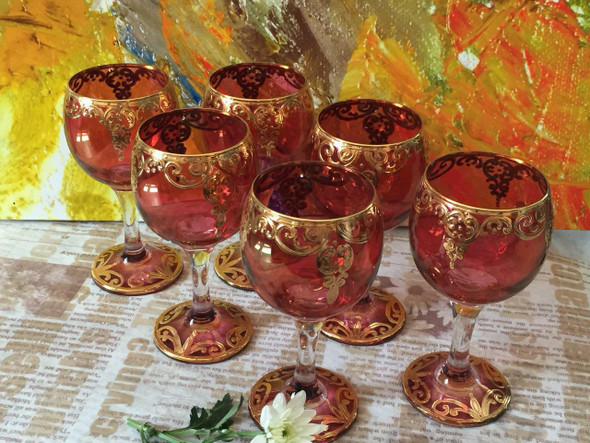 A premium 7-piece Qajar style decorative wine set featuring a red hand-painted decanter and 6 matching red glasses with gold motifs.