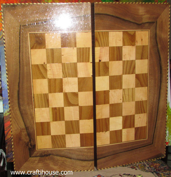 Detailed view of the thousands of tiny brass and wood stars forming the Khatam-kari frame of the board