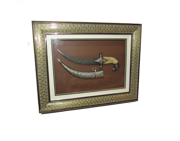 Close-up of the intricate hand-carved tiger head hilt made from polished white camel bone.