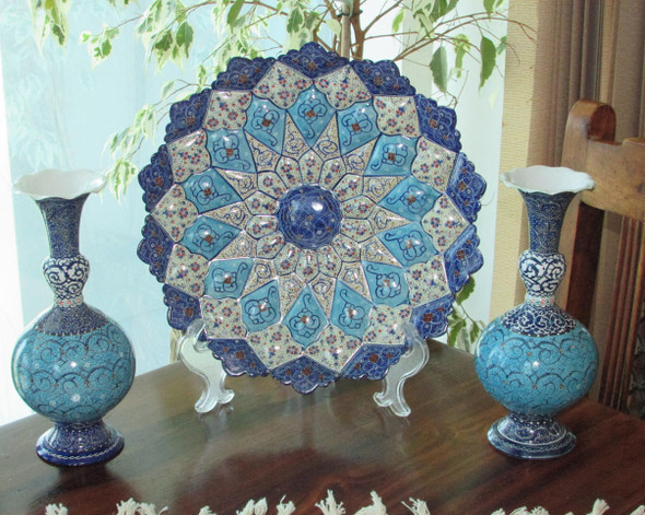 Close-up of the intricate hand-carved floral and geometric patterns on the surface of the handmade copper plate.