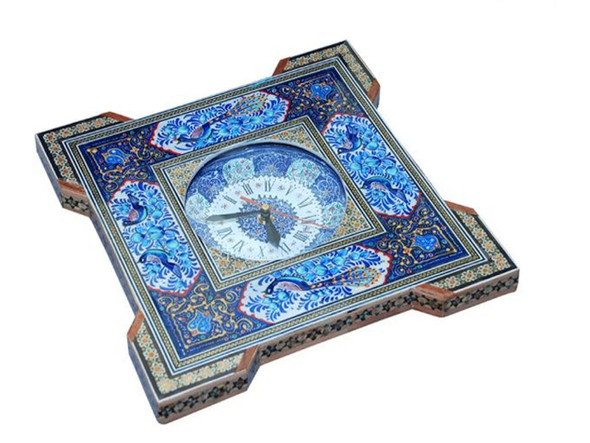 The handmade Khatamkari marquetry clock shown as a sophisticated wall-hanging feature in a modern luxury executive office.