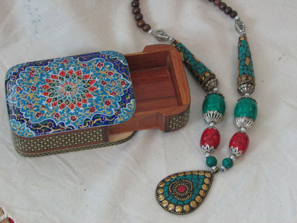 A macro shot of the lid showing the incredible detail of the hand-painted birds and flowers.