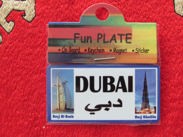 An elegantly designed aluminum "Fun Plate" magnet featuring the text "DUBAI" and Arabic calligraphy