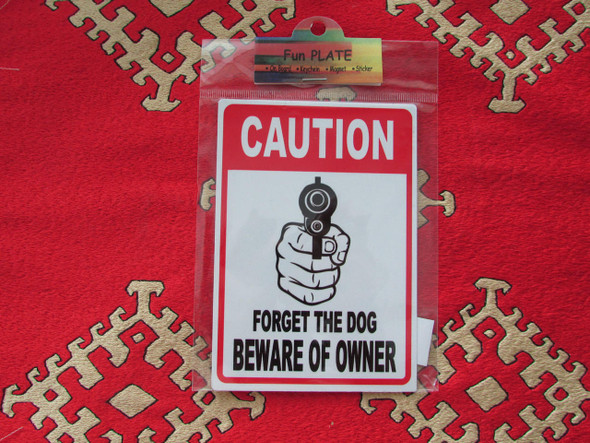 A vibrant 11x9 cm vertical aluminium fridge magnet featuring a humorous 'Caution' design with a fist holding a gun and the text 'Forget the dog, beware of owner'.