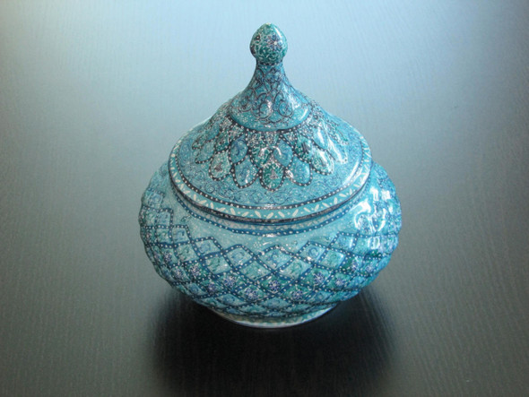 Detailed view of the intricate hand-painted floral motifs on the copper enamel surface of a candy bowl