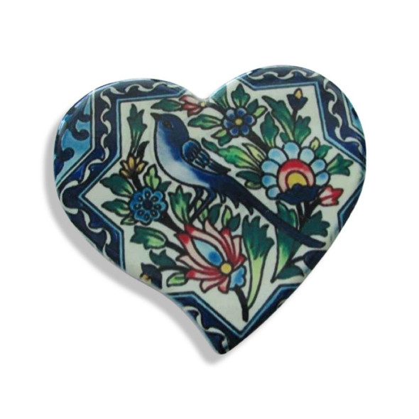 A heart-shaped printed ceramic fridge magnet featuring a traditional blue bird perched among intricate floral branches and leaves.