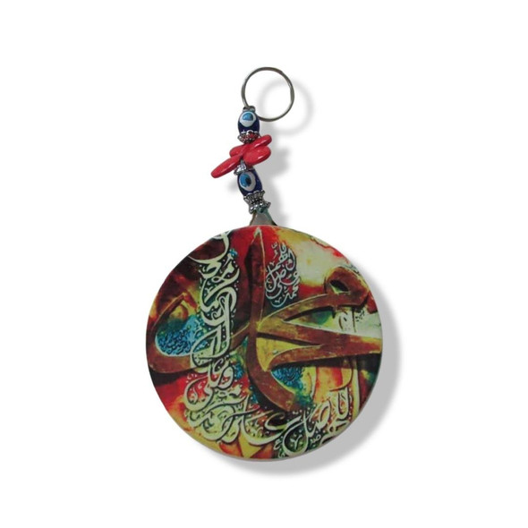 The round ceramic tile displayed fully, emphasizing the artistic calligraphy and the carefully arranged protective bead hanging.
