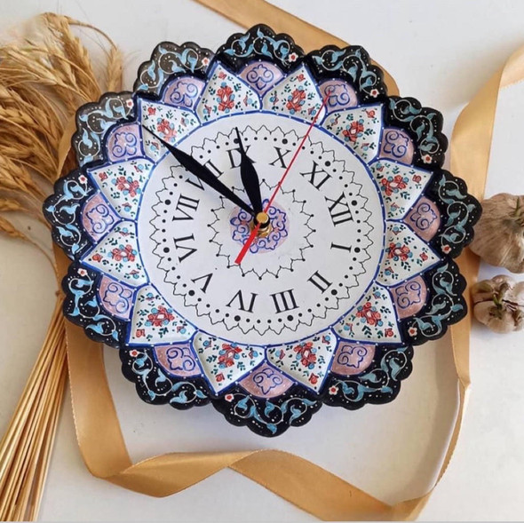 The Minakari copper clock displayed on a neutral-toned living room wall as a centerpiece decorative item