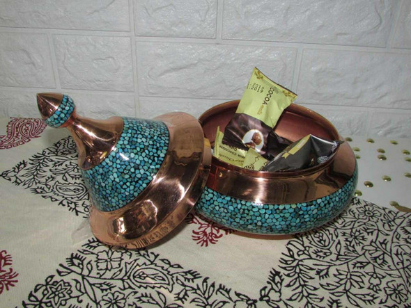 Close-up of the meticulous turquoise stone inlaying technique and the polished copper finish on the 17 cm candy bowl.