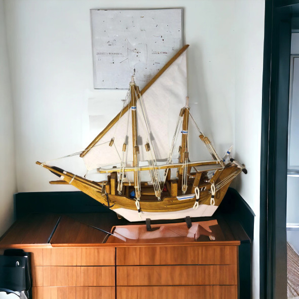 A stunning 15-inch masterpiece wooden dhow sculpture, meticulously hand-finished for an elite nautical display.