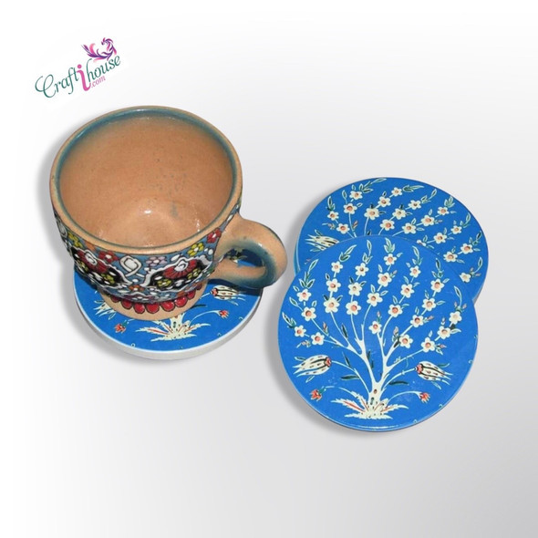 A round ceramic tea coaster featuring a stunning blue artistic pattern, ideal for protecting tabletops.