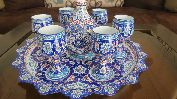 Close-up of the hand-painted floral motifs and Eslimi patterns on the neck of the Minakari copper pitcher.