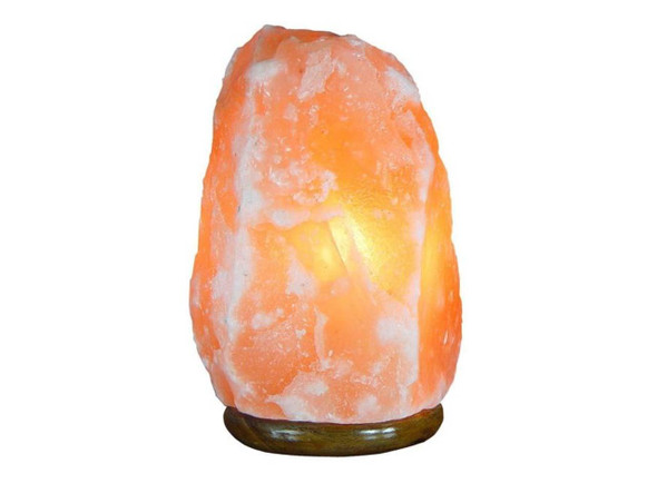Warm amber glow from a real Himalayan salt lamp, creating a relaxing atmosphere in a dark bedroom