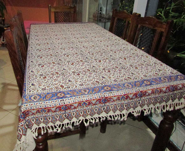 A 200x135 cm rectangular organic cotton tablecloth featuring earthy tones of indigo and walnut-shell dye in a traditional Persian pattern.