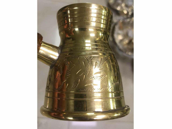 Close-up of the secure riveted connection between the brass body and the dark natural wooden handle.