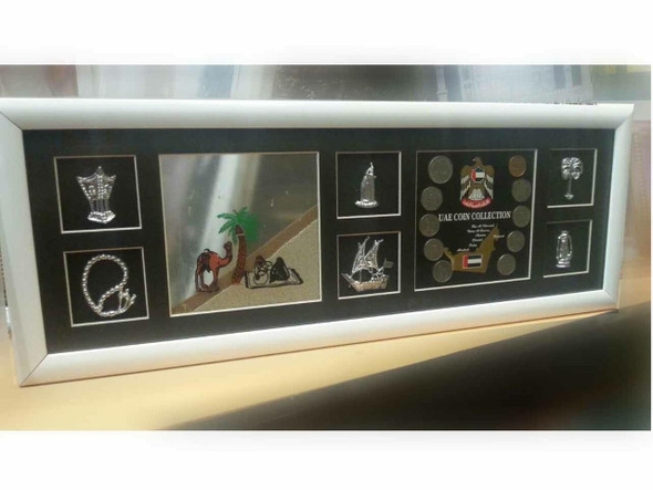Close-up of the UAE coin collection and traditional Emirati symbols framed in our 49x29 cm display