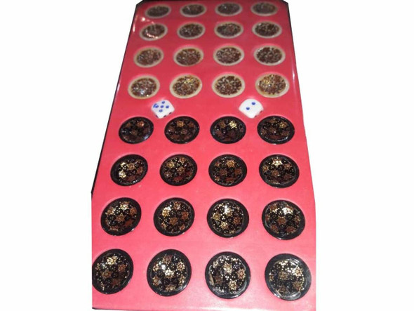 Light and dark wooden backgammon checkers stacked to show uniform handcrafted quality.