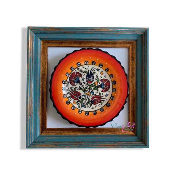 Close-up of the delicate hand-painted motifs and the brilliant glossy glaze of the Turkish plate within its professional frame.