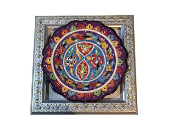 The 22x22 cm framed Turkish plate shown as a vibrant cultural accent on a modern living room wall, perfect as a birthday gift.