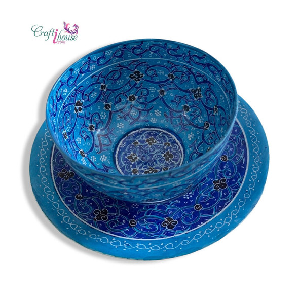 Close-up of the intricate hand-painted floral motifs and the glass-like fired finish on the Minakari copper plate and bowl.
