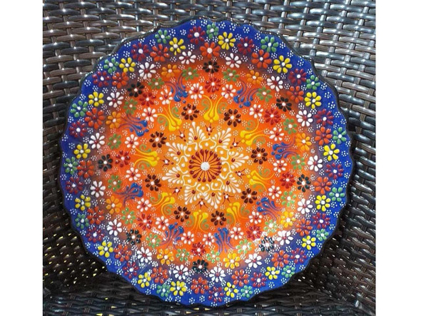 A professional product presentation of the exclusive 30 cm handmade assorted pattern wall and serving plate from a premier UAE gift shop.