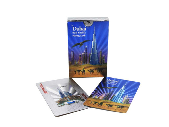 Close-up view of the metallic finish, vibrant skyscraper artwork, and card backs from the Dubai souvenir playing cards set.