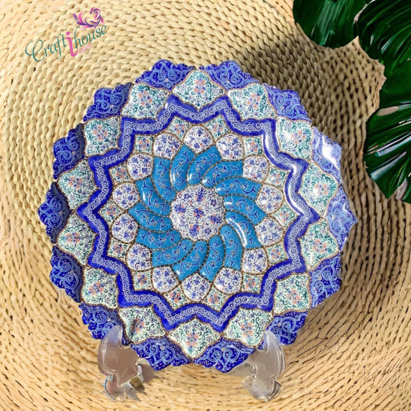 Close-up of the intricate hand-painted floral rosettes and the brilliant cobalt mineral pigments on the 30 cm Meenakari copper wall plate.