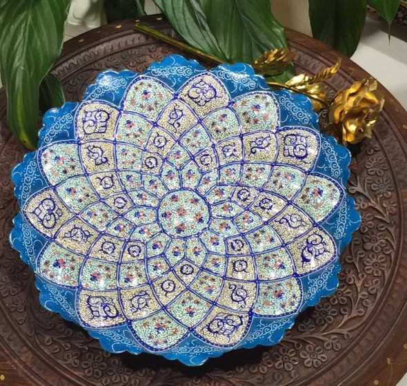 The "Azure Blossom" blue enamel plate shown as a prestigious decorative wall feature in a modern luxury Majlis setting in Dubai.