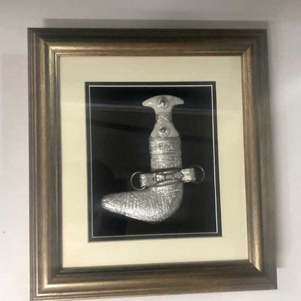 Silver framed Omani Khanjar hanging in a modern living room, a unique gift from Oman and a premium Dubai souvenir.