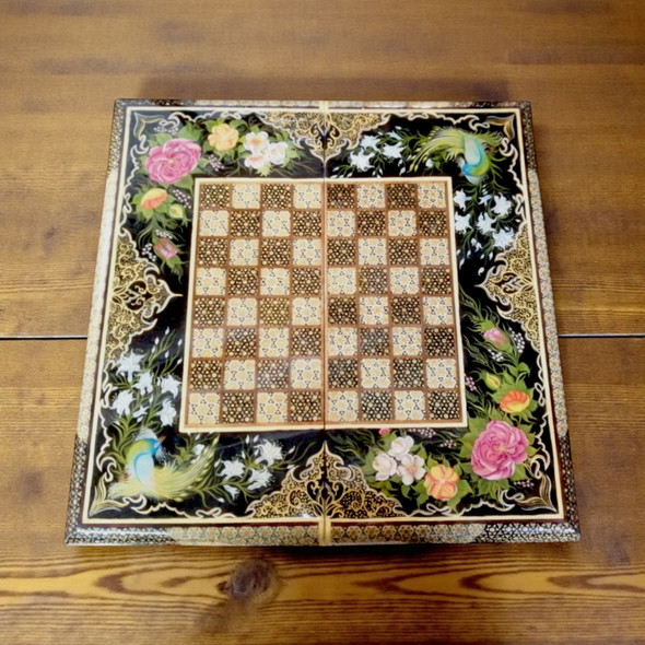 luxury backgammon set interior showing intricate Persian marquetry and hand-painted floral details on the playing field.