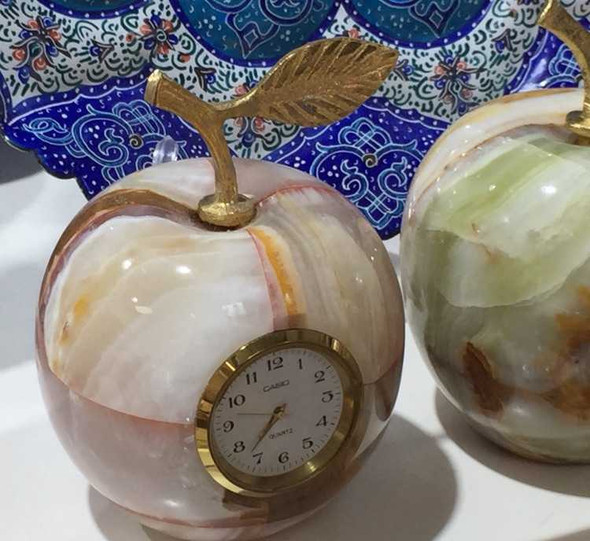 A professional product presentation of the authentic carved natural stone apple clock gift from a premier art, gift, and home decor supplier.