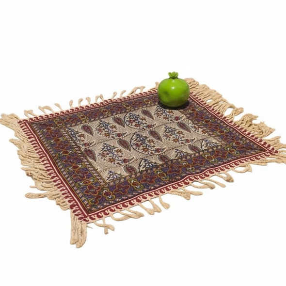 A 40x40 cm handmade Ghalamkari cotton place mat featuring cream paisley patterns and a red floral border with fringe.