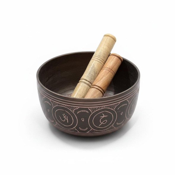 A premium vintage-style Tibetan singing bowl featuring an antique hand-hammered finish, shown with a wooden striker and silk cushion.