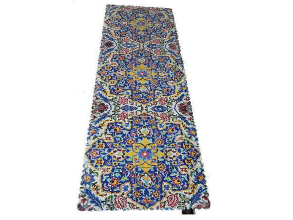 A 130x50 cm printed velvet table runner featuring a vibrant blue, yellow, and red mosaic tile floral pattern with a decorative vase on top.