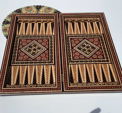 Macro view of the intricate star-patterned Khatamkari mosaic made of wood, bone, and brass on a 40cm board.